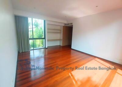 Spacious living room with wooden flooring and large window