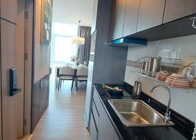 Modern kitchen leading to dining area with bright window