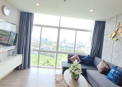 Modern living room with large windows and city view