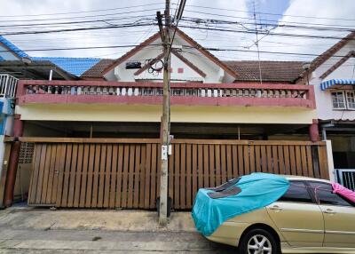 Exterior view of residential building with car parked in front