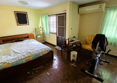 Bedroom with a bed, window, desk, and exercise bike