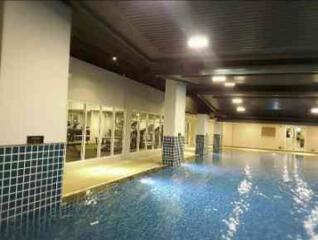 Indoor swimming pool area with gym view