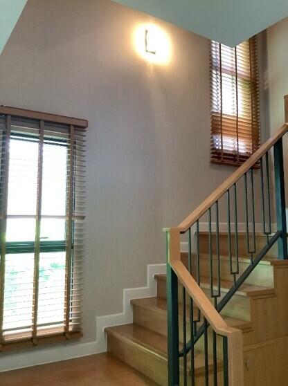 Well-lit staircase with wooden steps and handrail