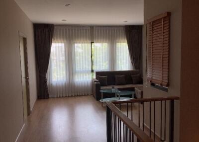 Living room with large window, sofa, and glass coffee table