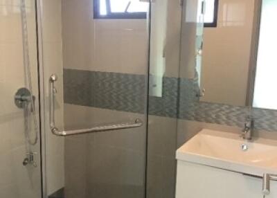 Modern bathroom with glass shower enclosure and vanity