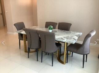 Elegant dining room with marble table and six chairs