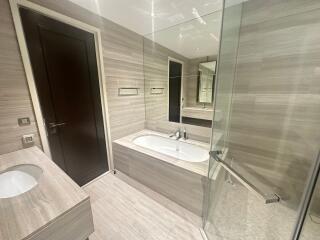 Modern bathroom with bathtub and glass shower enclosure