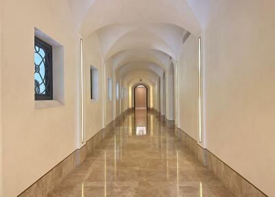 Long hallway with arched ceiling and marble floor