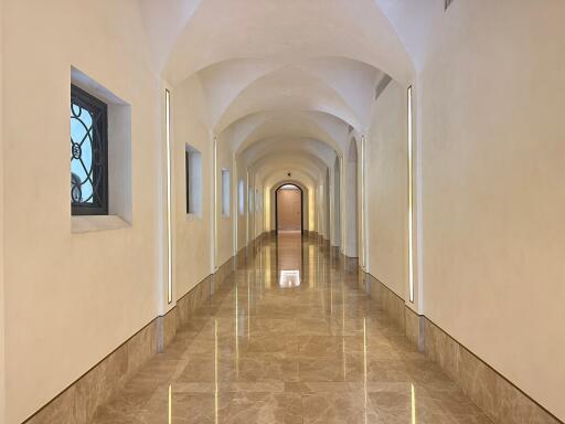 Long hallway with arched ceiling and marble floor