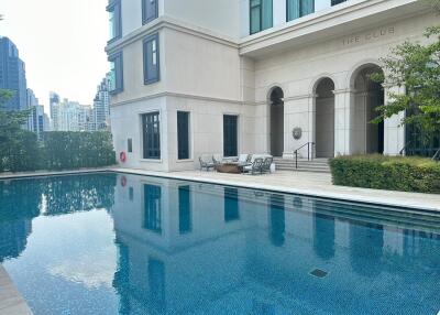 Outdoor swimming pool next to a building