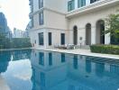 Outdoor swimming pool next to a building