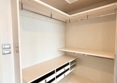 Spacious walk-in closet with shelving and hanging space