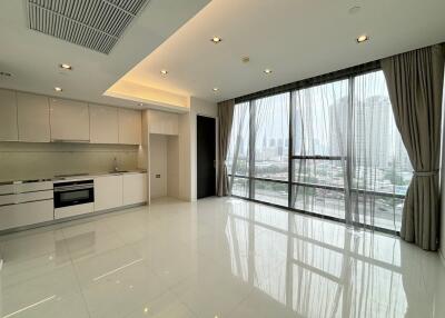 Spacious living room with floor-to-ceiling windows and modern kitchen