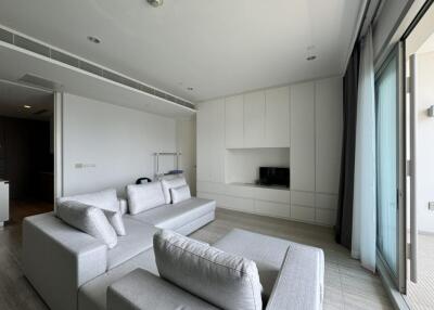 Modern living room with light grey sofas and built-in storage cabinets