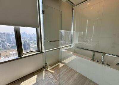 Modern bathroom with glass shower and city view