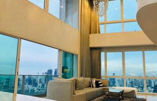 Spacious modern living room with large windows and city view