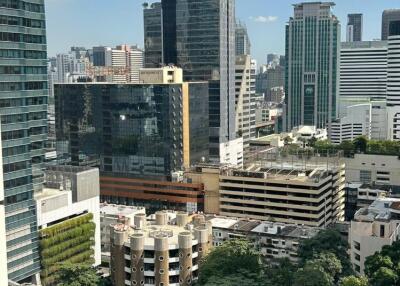 View of city skyline with buildings and greenery