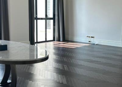 Bright living room with dark hardwood floors and large windows