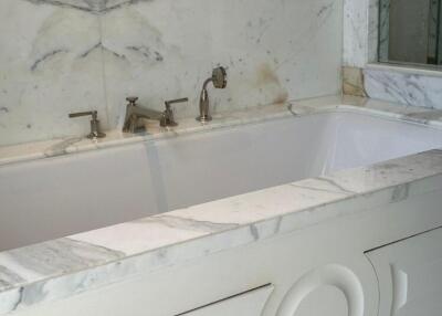 Luxury bathroom with marble bathtub and fixtures