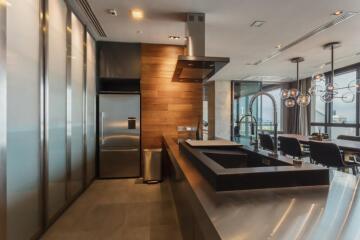 Modern kitchen with stainless steel appliances and dining area