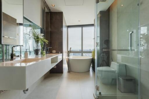 Modern bathroom with glass enclosures and a large window