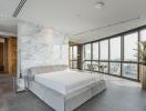 Spacious modern bedroom with large windows and a view