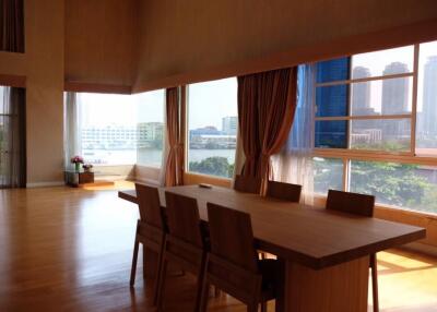 Spacious dining room with large windows and wood flooring