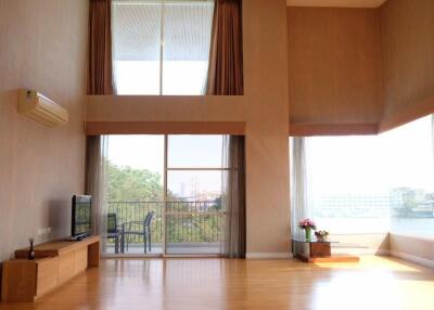 Spacious living room with large windows and balcony