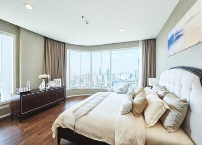 Spacious modern bedroom with large windows and city view