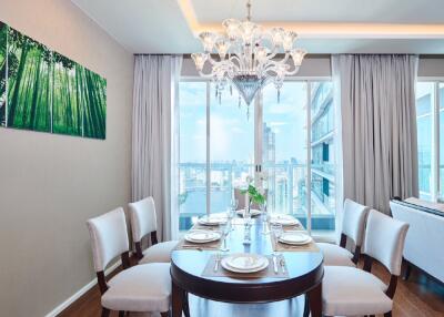 Elegant dining room with a chandelier and city view