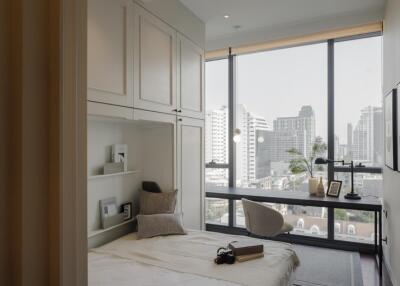 Modern bedroom with large windows and a city view