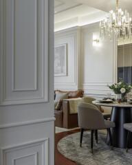 Elegant living room with a dining area and ornate chandelier