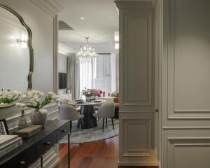 Well-decorated living room with a chandelier and dining area