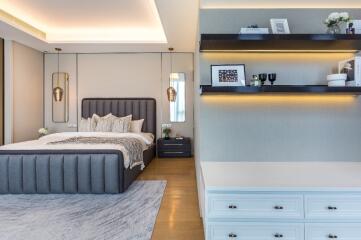 Modern bedroom with a luxurious bed, stylish lighting, and shelves with decor items