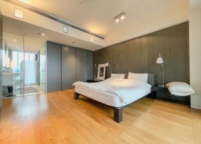 Spacious bedroom with wooden flooring and modern decor