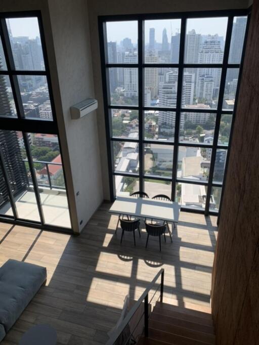 Living room with large windows and city view