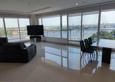 Spacious living room with panoramic windows and balcony view