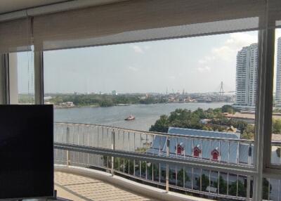 Living room with large windows and a view of the river