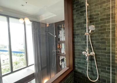 Modern bathroom with green tiles and large window