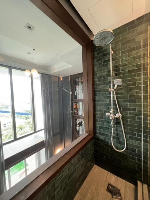 Modern bathroom with green tiles and large window