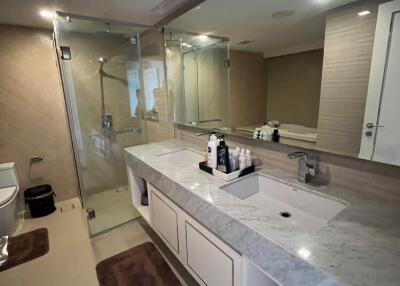 Modern bathroom with large mirror and glass-enclosed shower