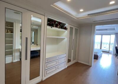 Spacious bedroom with built-in wardrobe and large windows