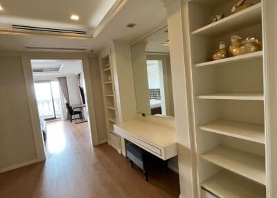 Wide hallway with built-in shelving and a vanity desk