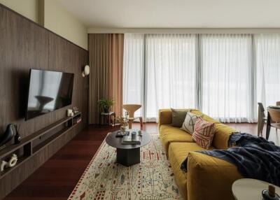 Modern living room with large windows and yellow sofa