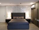 Modern bedroom with marble accent wall and stylish furniture