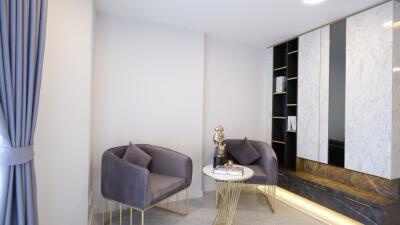 Modern living area with stylish chairs and a decorative cabinet