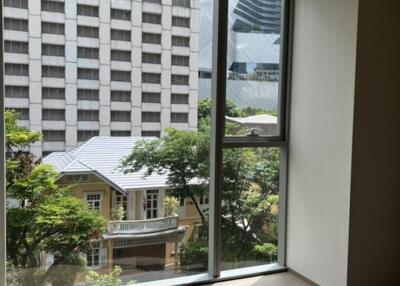 View of city building and greenery from large window