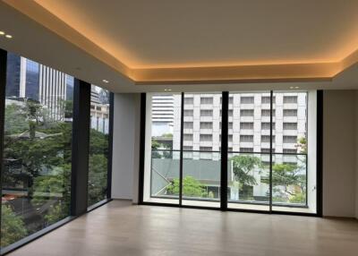 Spacious living room with large windows and city view