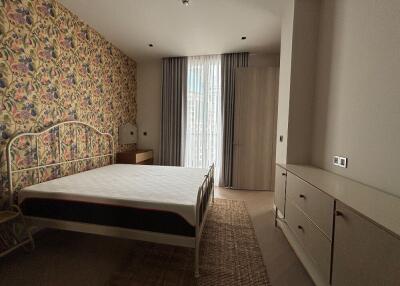 Bedroom with floral wallpaper and modern furniture