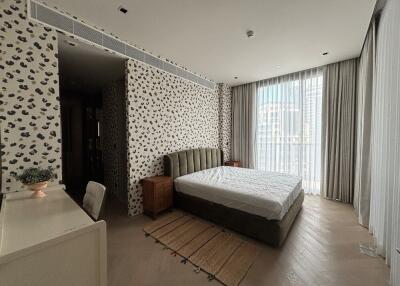 Modern bedroom with large window and patterned wallpaper